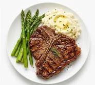 10oz-T-Bone-Steak-Classic-Dinner A 10 oz T-bone steak with grilled asparagus and mashed potatoes.