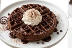 Triple-Chocolate-Waffle-Indulgent-Dessert Decadent chocolate waffle topped with chocolate chips, syrup, and whipped cream.